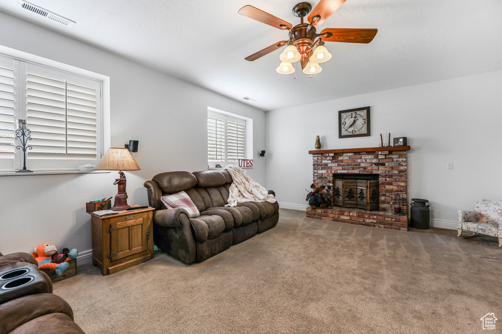Living room featuring baseboards, carpet floors, a ceiling fan, and visible vents
