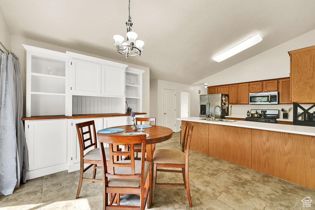 Dining room with vaulted ceiling and a chandelier