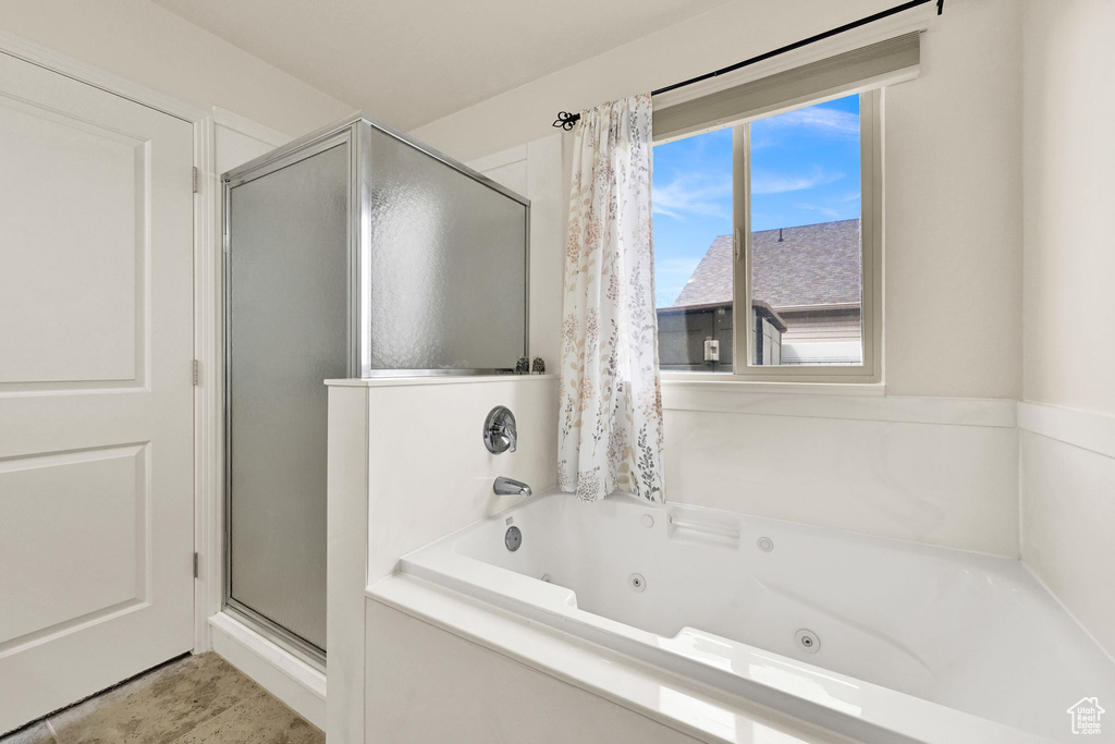 Full bathroom with a stall shower and a tub with jets