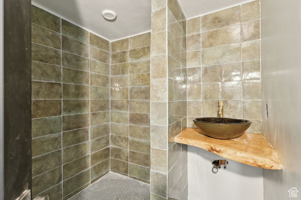 Bathroom featuring tile walls and a sink