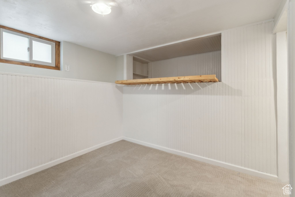 Finished basement featuring carpet floors and baseboards