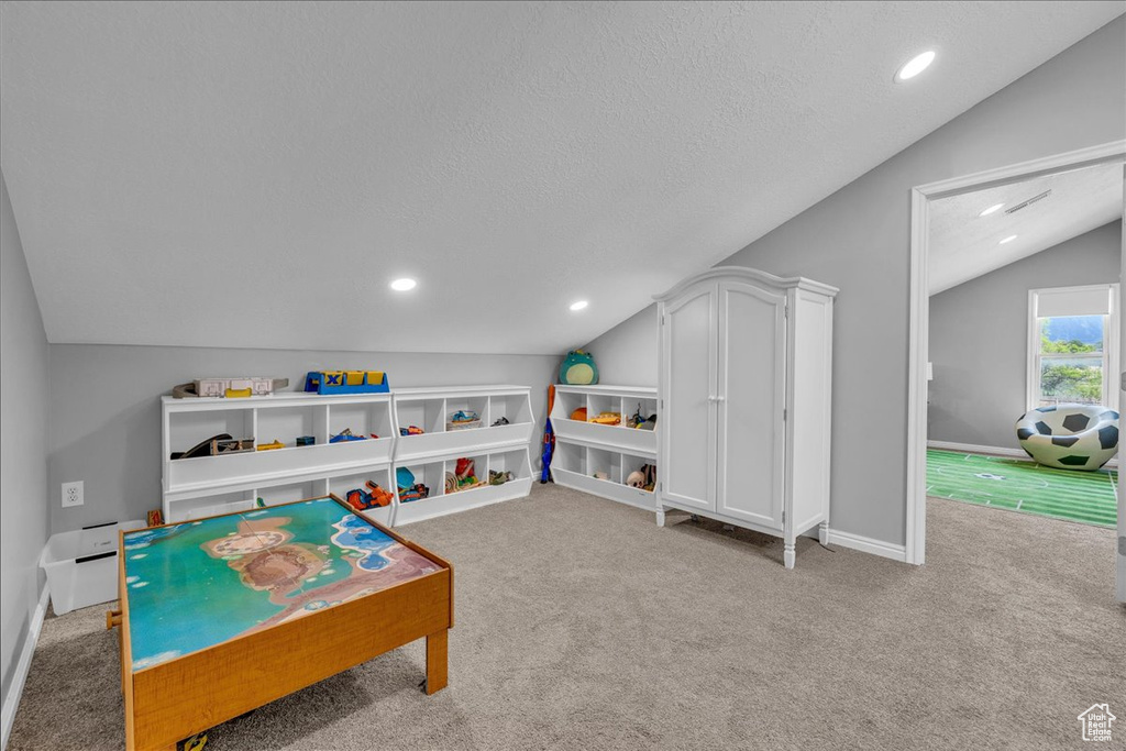 Game room featuring vaulted ceiling, carpet flooring, baseboards, a textured ceiling, and recessed lighting