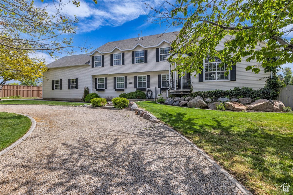 View of front of house featuring gravel driveway