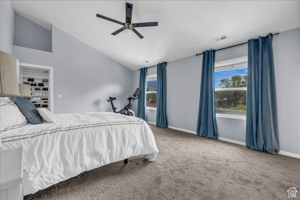 Bedroom featuring lofted ceiling, carpet, baseboards, and ceiling fan