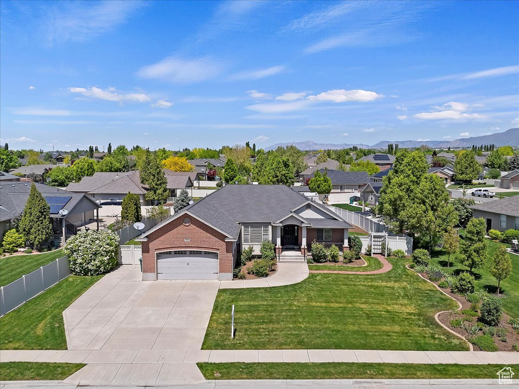 Single story home with a residential view, concrete driveway, and a garage