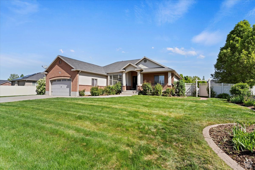 View of front of property featuring brick siding, a garage, and driveway
