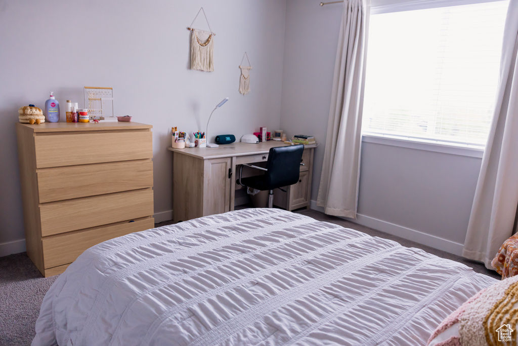 Carpeted bedroom with baseboards
