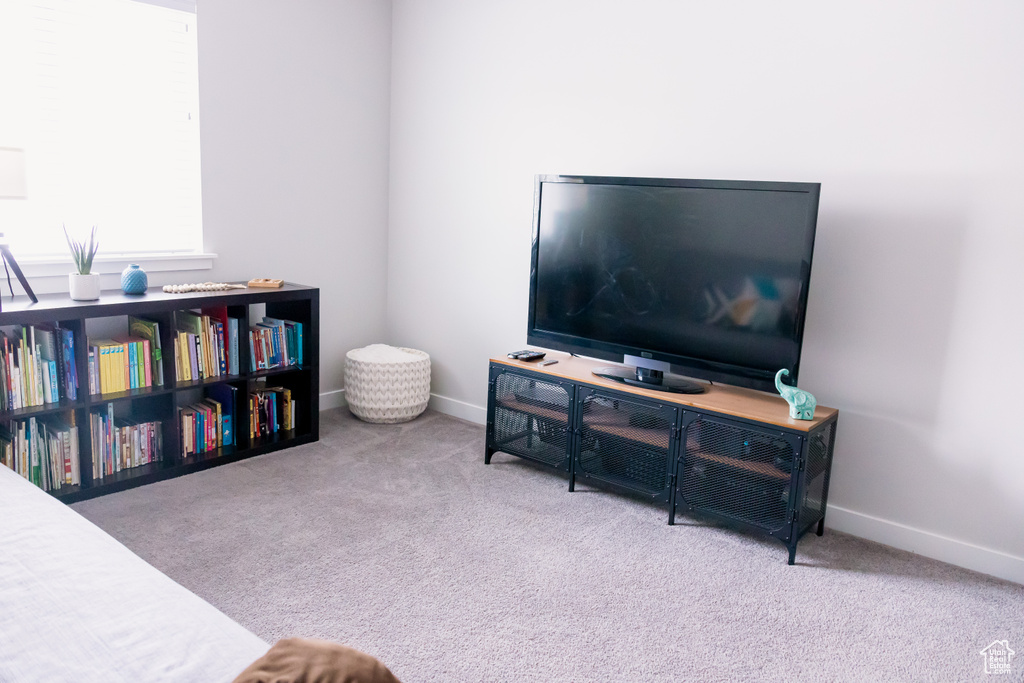 Carpeted living room featuring baseboards