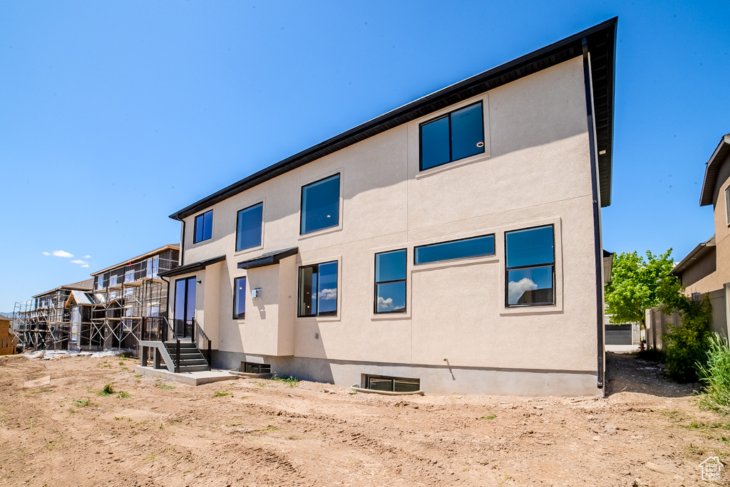 Rear view of house with stucco siding