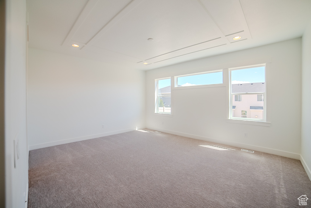 Carpeted spare room featuring baseboards, recessed lighting, and attic access