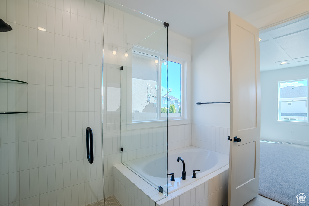 Full bathroom with a stall shower and a bath