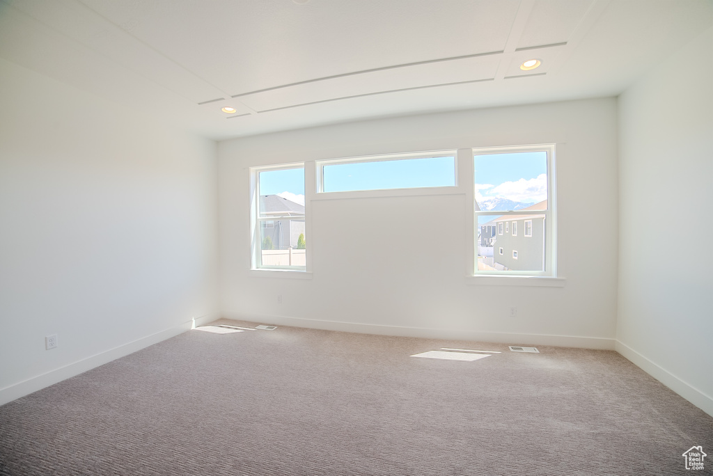 Carpeted empty room with recessed lighting, baseboards, and attic access