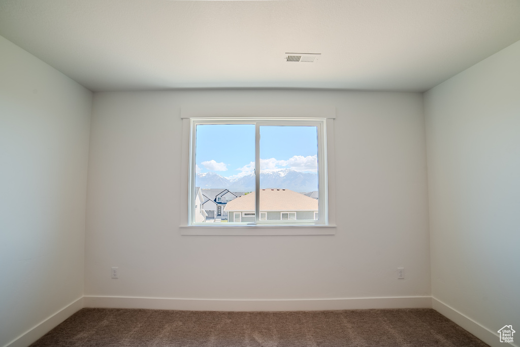 Unfurnished room featuring carpet flooring and baseboards