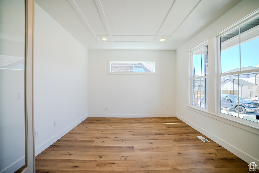Unfurnished room featuring healthy amount of natural light, light wood finished floors, baseboards, and recessed lighting