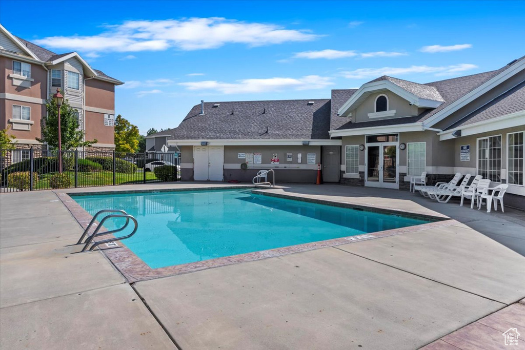 Pool featuring fence and a patio area