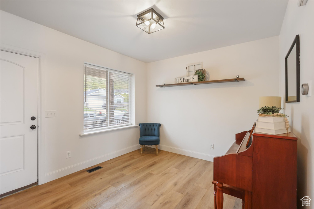 Living area with light wood finished floors and baseboards