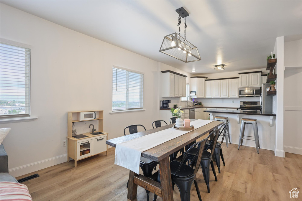 Dining area with light wood finished floors and baseboards