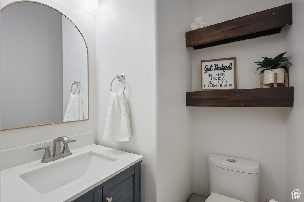 Half bathroom with toilet and vanity