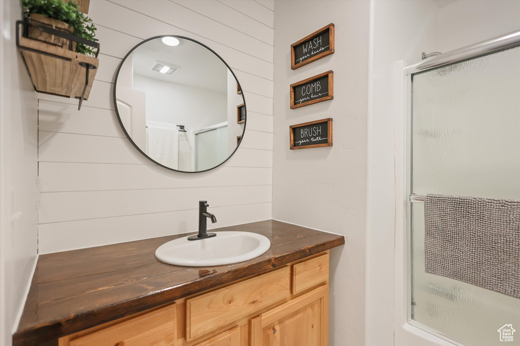 Bathroom featuring vanity and wooden walls