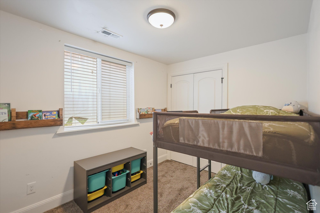 Carpeted bedroom featuring baseboards