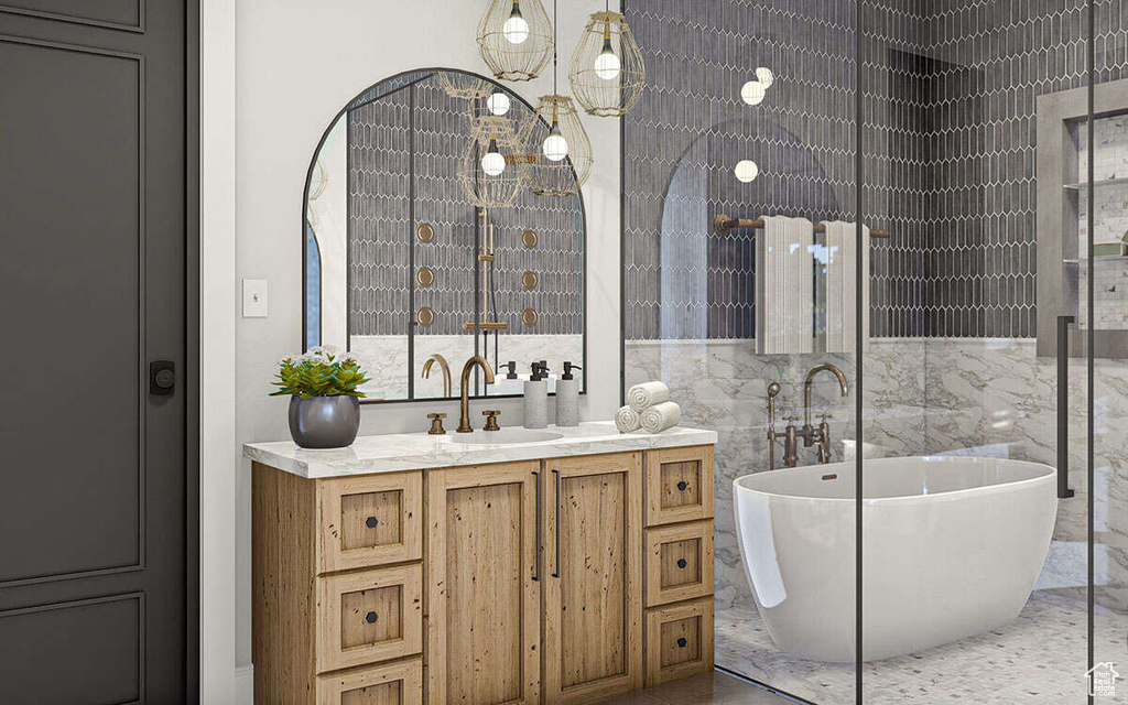 Full bathroom featuring a freestanding tub, tile walls, vanity, and marble finish floor