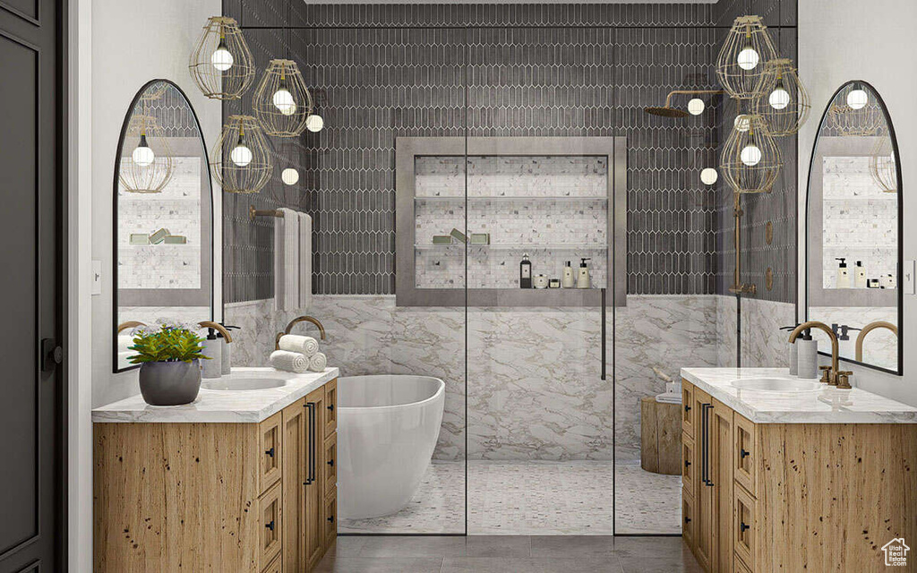 Bathroom featuring a sink, tile walls, and two vanities