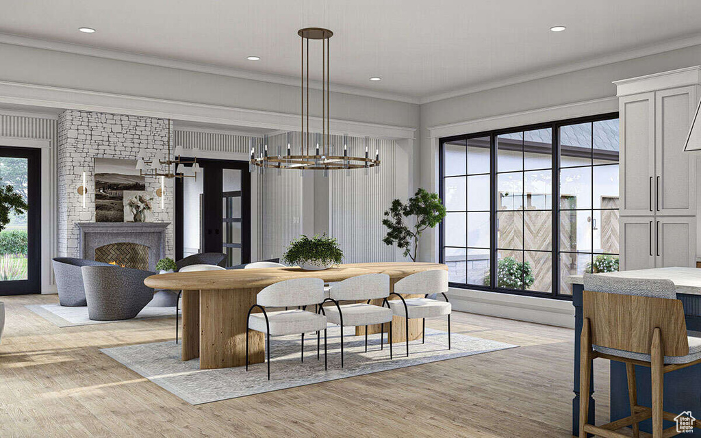 Dining room featuring crown molding, a notable chandelier, light wood finished floors, a large fireplace, and recessed lighting