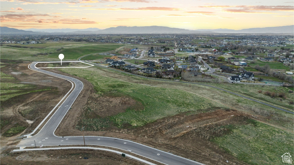 Aerial view of property and surrounding area with a mountainous background