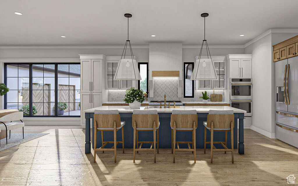 Kitchen featuring a sink, appliances with stainless steel finishes, crown molding, and light countertops