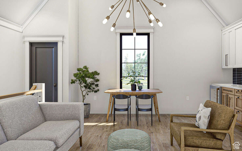Interior space featuring a notable chandelier, wood finished floors, and lofted ceiling