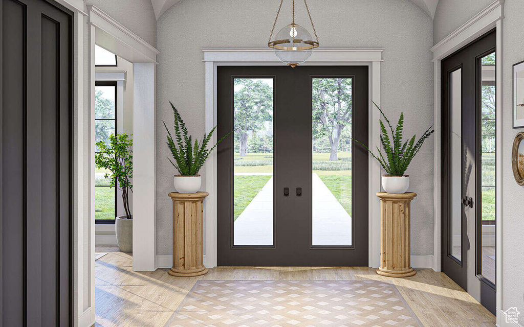 Foyer entrance featuring baseboards and french doors