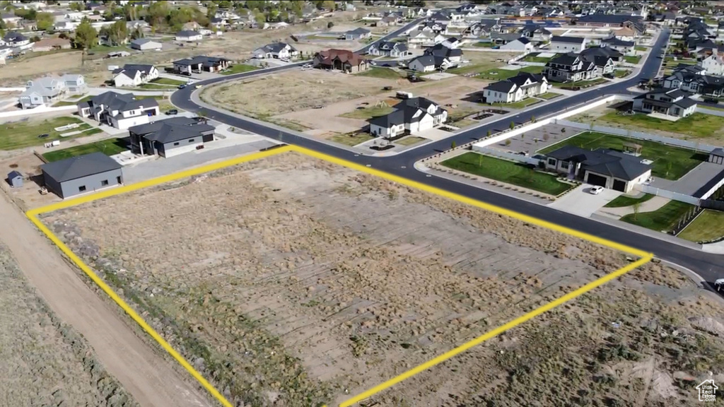 Aerial view of residential area with property parcel outlined