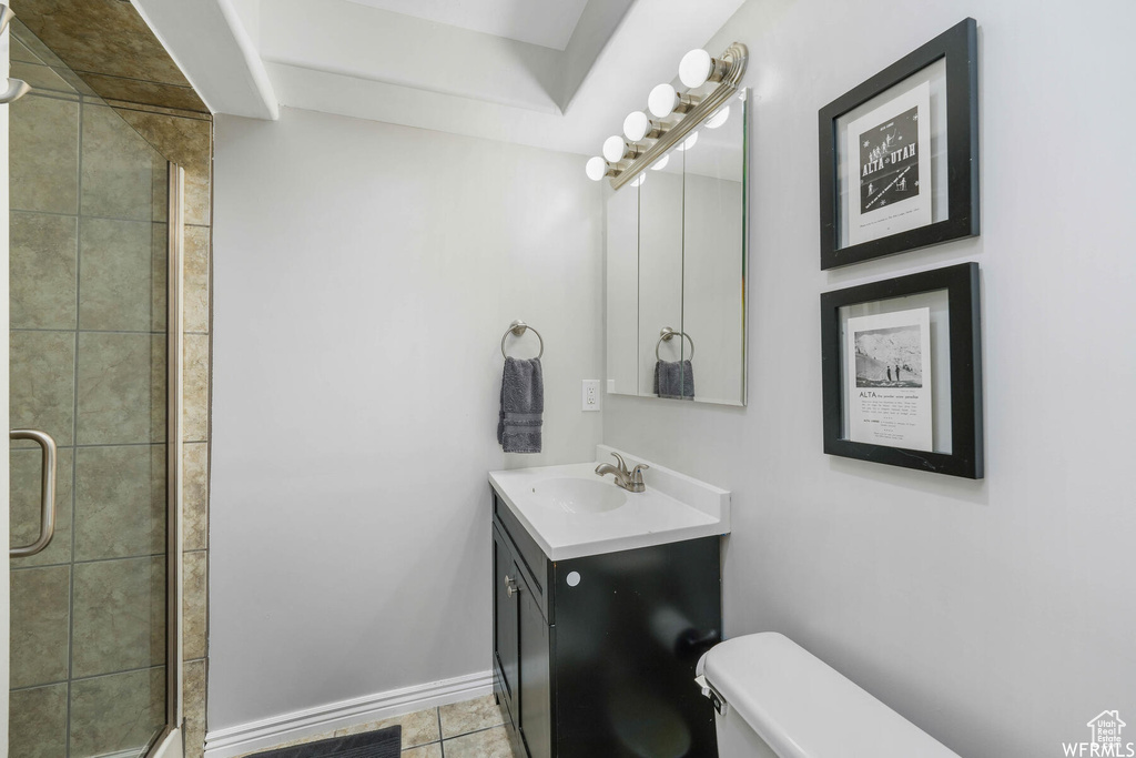 Bathroom featuring vanity, a shower stall, and tile patterned flooring