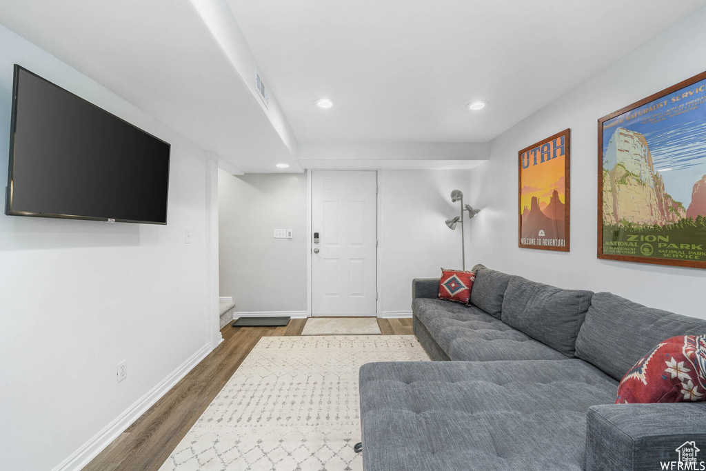 Living room featuring wood finished floors and recessed lighting