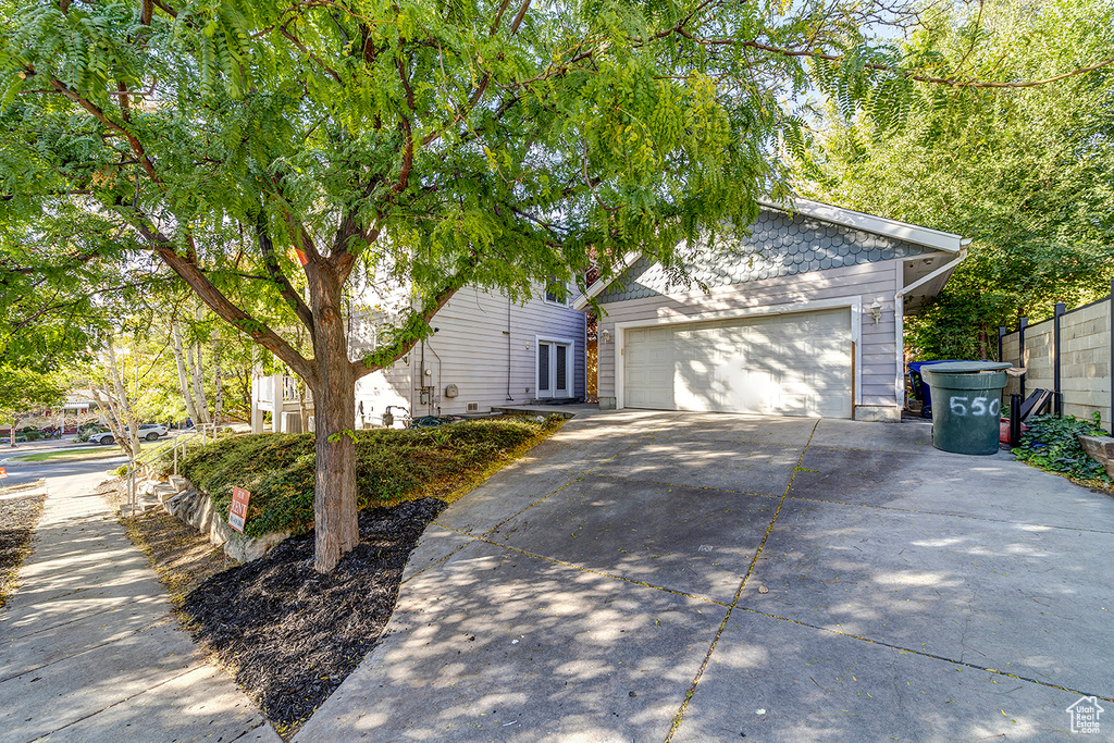 Obstructed view of property with driveway and a garage