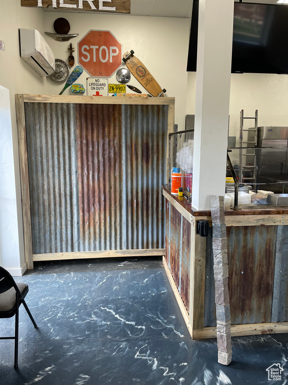 Bar with concrete flooring and an AC wall unit