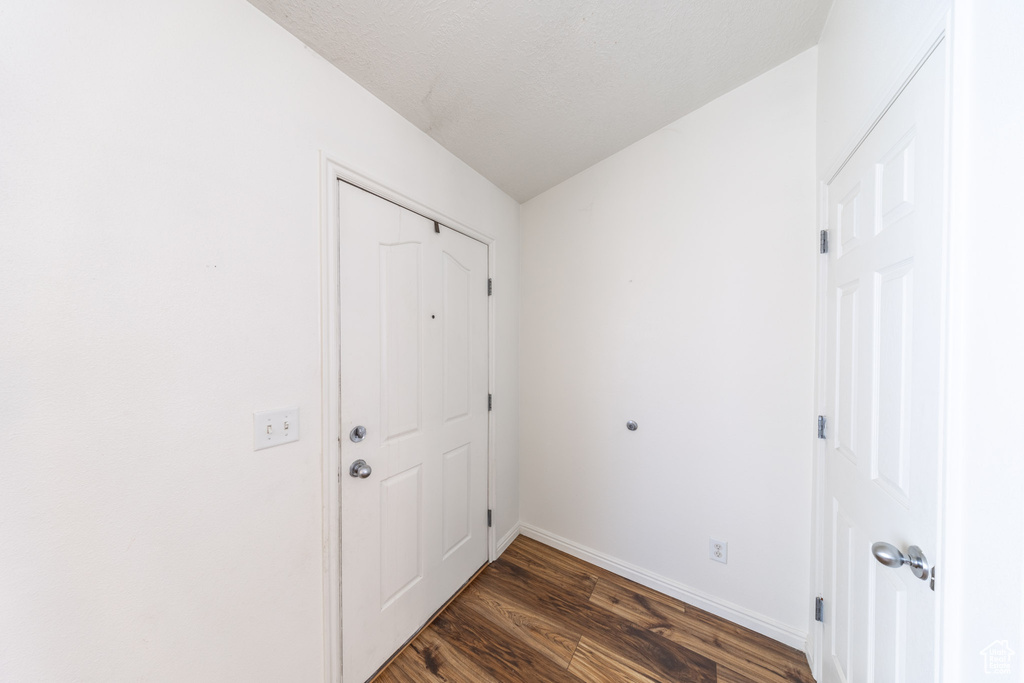 Doorway featuring wood finished floors and baseboards