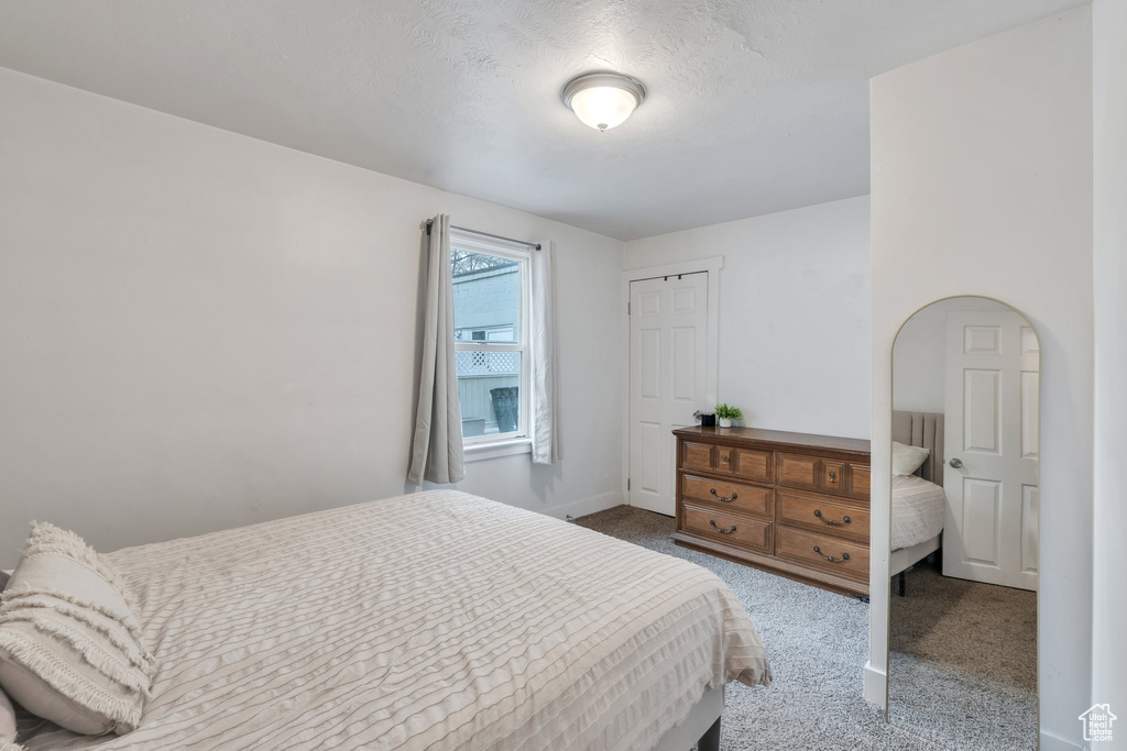 Bedroom featuring carpet flooring and baseboards