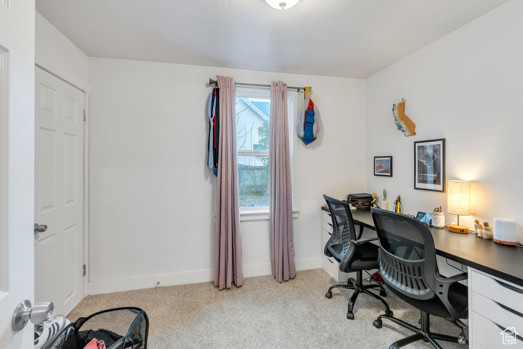 Carpeted office space featuring baseboards