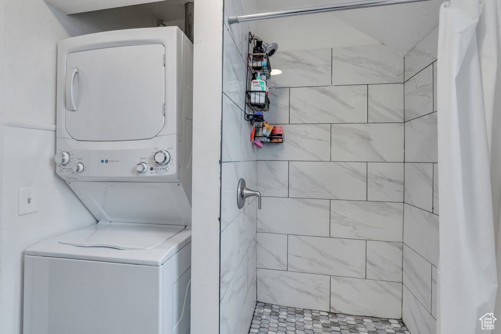 Laundry room with stacked washing machine and dryer