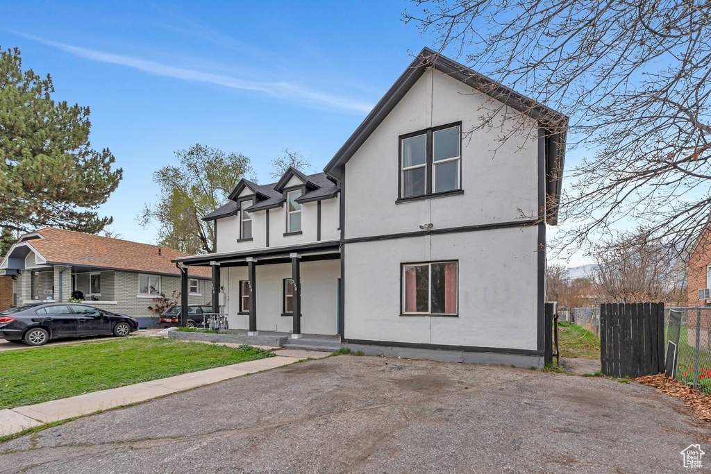 View of front of property featuring covered porch and stucco siding