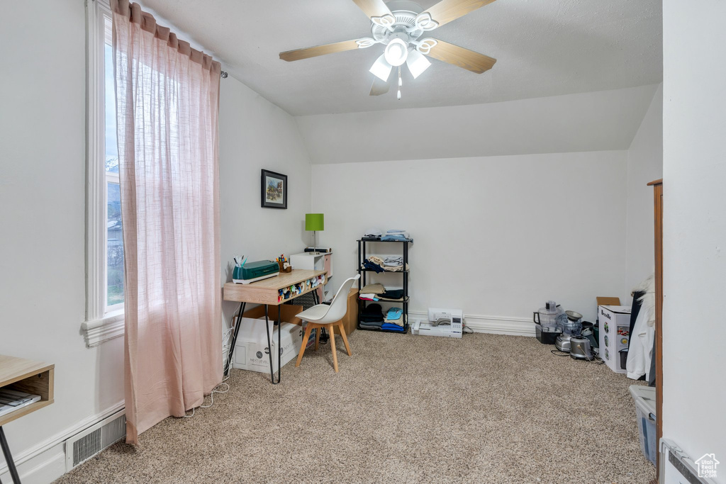 Office area featuring carpet floors, vaulted ceiling, and a ceiling fan