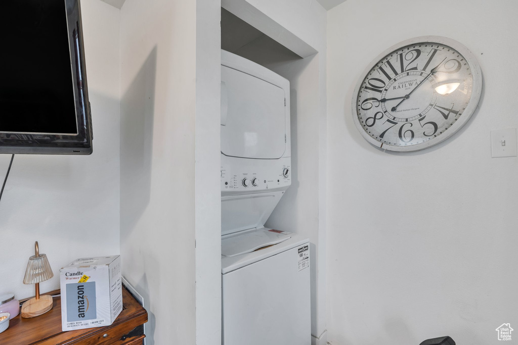 Washroom featuring stacked washing machine and dryer