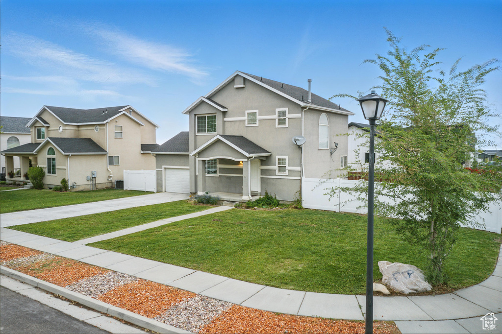 View of front of house featuring driveway and stucco siding