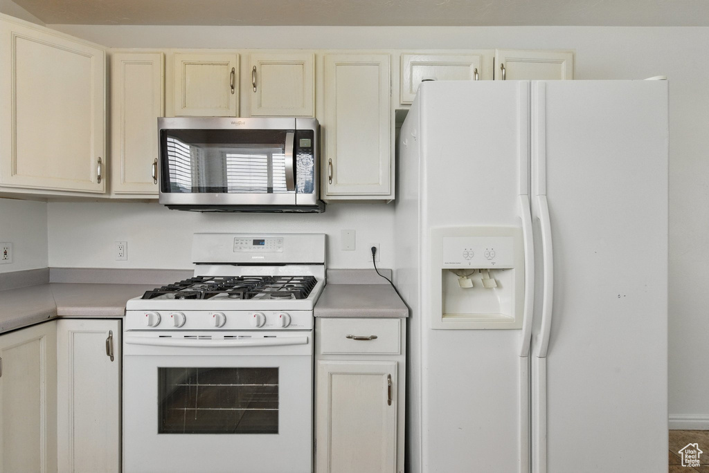 Kitchen featuring white appliances and light countertops
