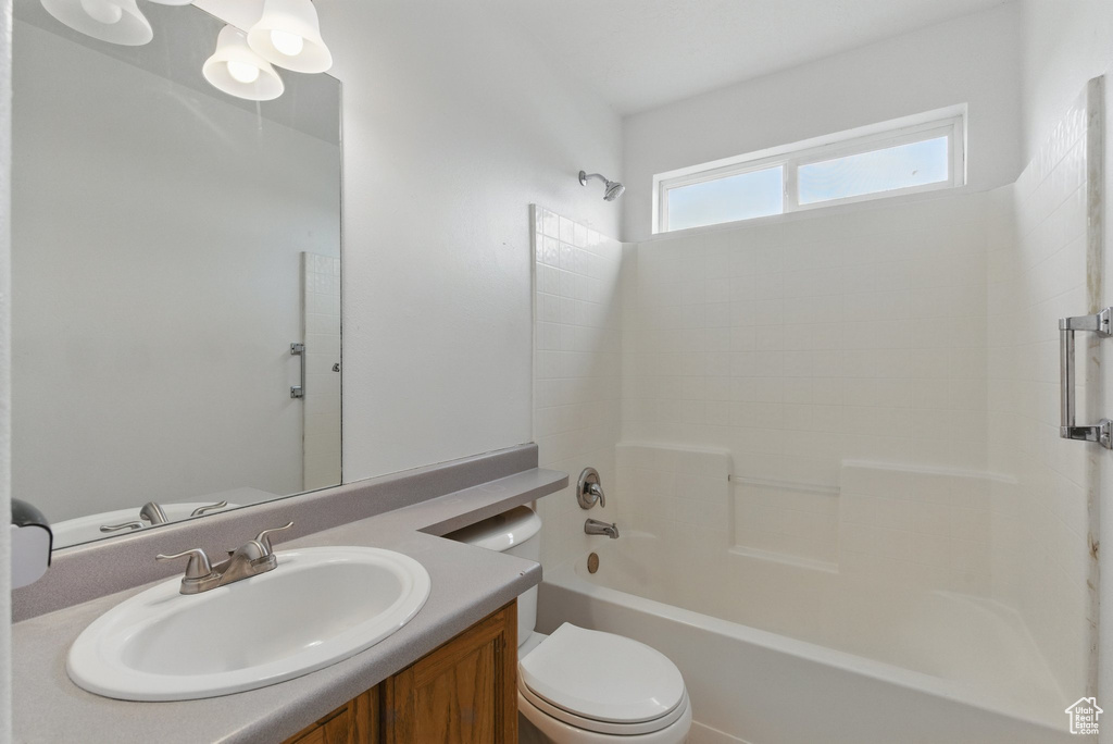 Full bath with toilet, vanity, and tub / shower combination