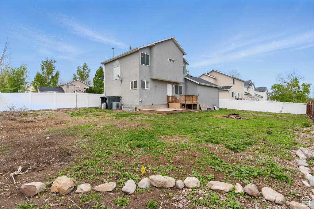 Rear view of house featuring a wooden deck