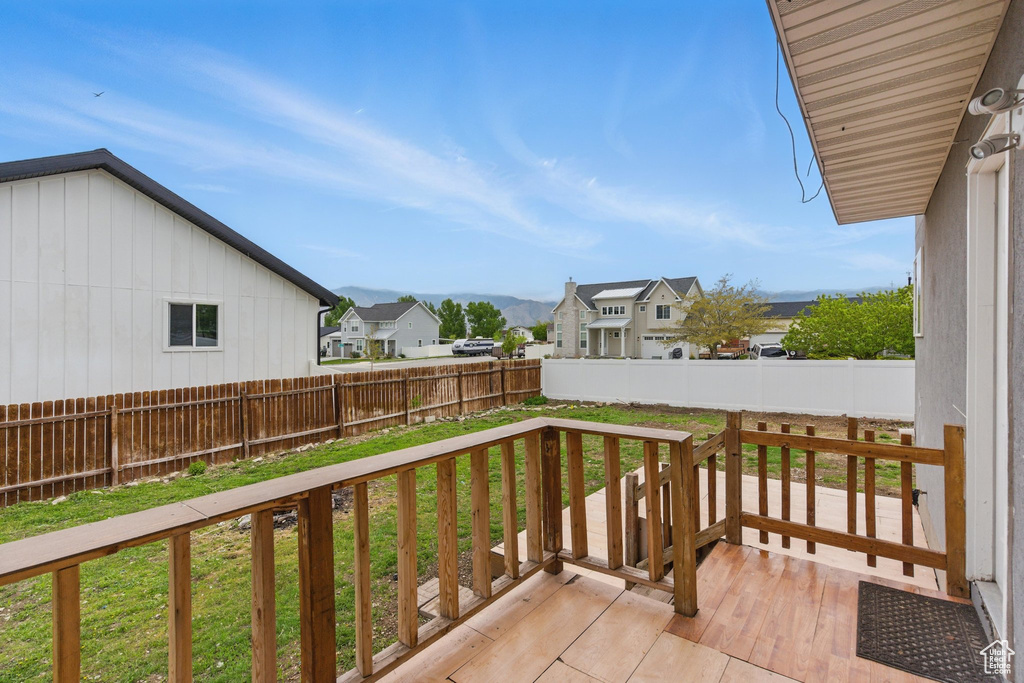 View of wooden balcony with a residential view and a deck