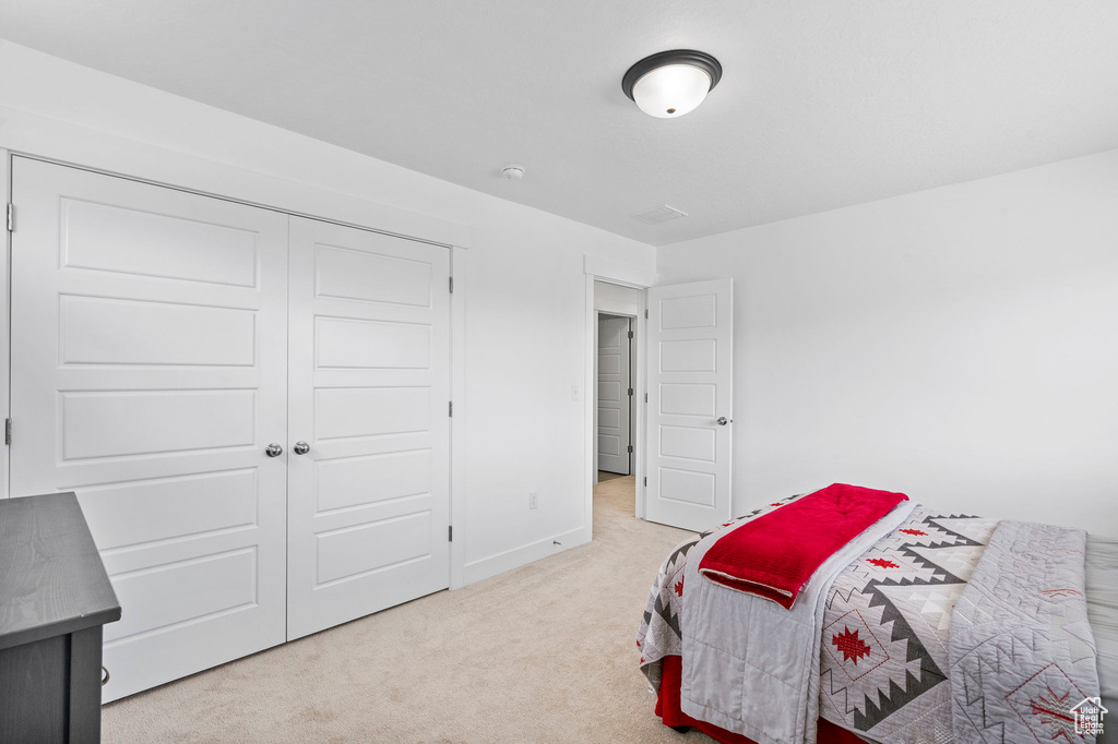 Bedroom with carpet flooring and baseboards
