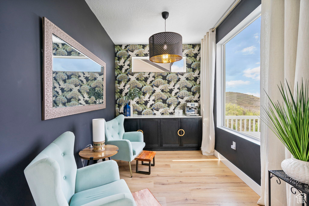 Living area with plenty of natural light, light wood-type flooring, and baseboards